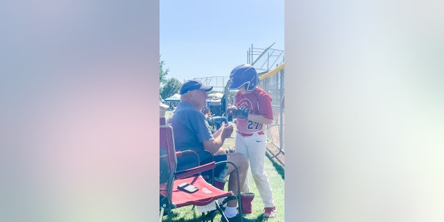 Felix chats with his grandpa during one of his ball games in North Dakota.