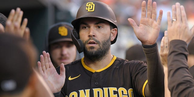 Eric Hosmer of the San Diego Padres high fives during a game against the Detroit Tigers at Comerica Park on July 25, 2022 in Detroit, Michigan.