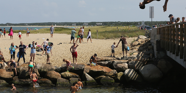 A boy jumps off "Jaws Bridge" during JawsFest: The Tribute, a festival celebrating the 1975 film "Jaws," on the island of Martha’s Vineyard.