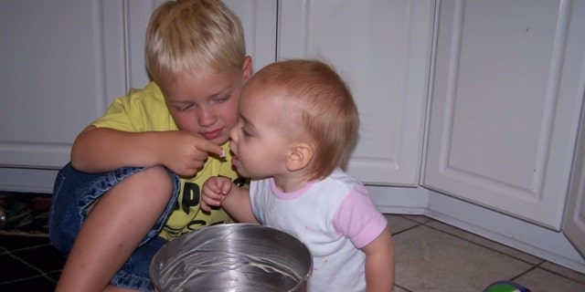 Sydney loved her "brutters," also known as her "brothers," her mom said. In this image, big brother Mason is feeding little Sydney. 