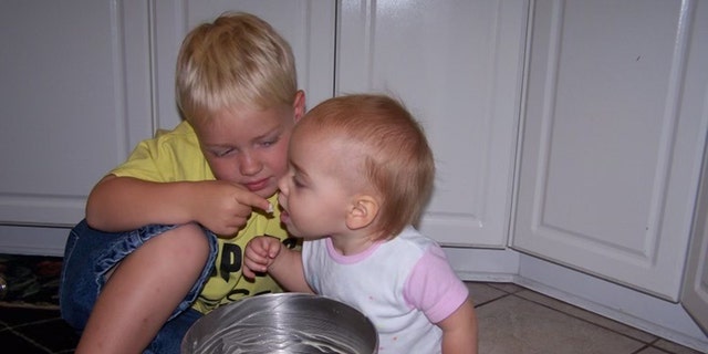 Sydney loved her "brutters," also known as her "brothers," her mom said. In this image, big brother Mason is feeding little Sydney. 