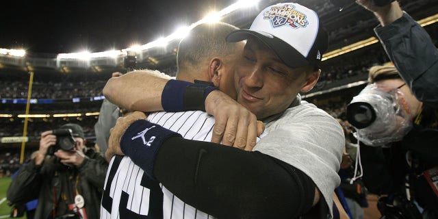 Derek Jeter, No. 2, and Alex Rodriguez, No. 13 of the New York Yankees, celebrate victory on the field after a 7-3 victory over the Philadelphia Phillies in Game 6 of the 2009 MLB World Series at Yankee Stadium on November 4 2009. Bronx area in New York.