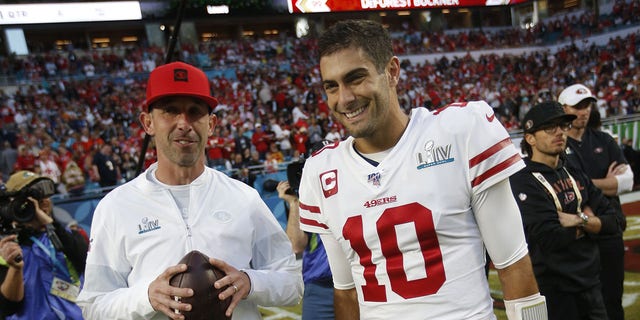 Head coach Kyle Shanahan and Jimmy Garoppolo #10 of the San Francisco 49ers talk on the field before the game against the Kansas City Chiefs in Super Bowl LIV at Hard Rock Stadium on February 2, 2020 in Miami, Florida.  The Chiefs defeated the 49ers 31-20.