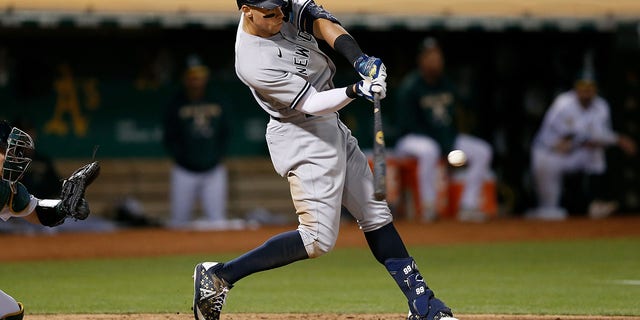 Aaron Judge #99 of the New York Yankees hits a three-run home run in the top of the fifth inning against the Oakland Athletics at RingCentral Coliseum on August 26, 2022 in Oakland, California.