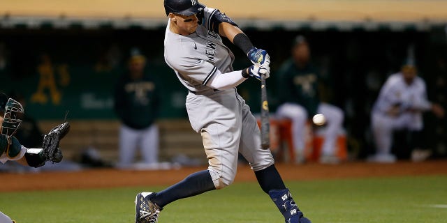 Aaron Judge #99 of the New York Yankees hits a three-run home run in the top of the fifth inning against the Oakland Athletics at RingCentral Coliseum on August 26, 2022 in Oakland, California.