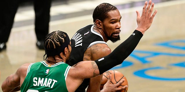 Kevin Durant #7 of the Brooklyn Nets is defended by Marcus Smart #36 of the Boston Celtics during a first round game of the 2021 NBA Playoffs at Barclays Center on May 22, 2021 in New York City.