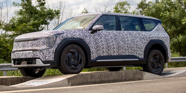 The Kia EV9 will be the brand's largest electric vehicle. This prototype features a patterned wrap designed to camouflage its details.