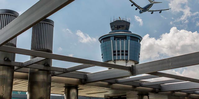 A plane flies over LaGuardia.