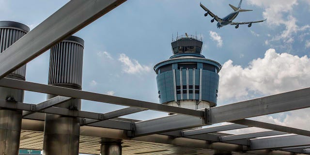 A plane flies over LaGuardia.