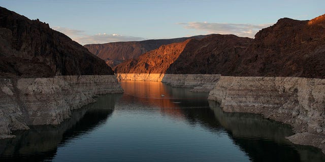 A bathtub ring of light minerals shows the high water line of Lake Mead near Hoover Dam at the Lake Mead National Recreation Area near Boulder City, Nevada, June 26, 2022. Multiple sets of human remains were found in Lake Mead last year due to the conditions.