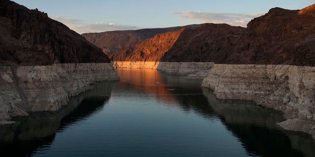 A bathtub ring of light minerals shows the high water line of Lake Mead near Hoover Dam at the Lake Mead National Recreation Area near Boulder City, Nevada, June 26, 2022. Multiple sets of human remains were found in Lake Mead last year due to the conditions.