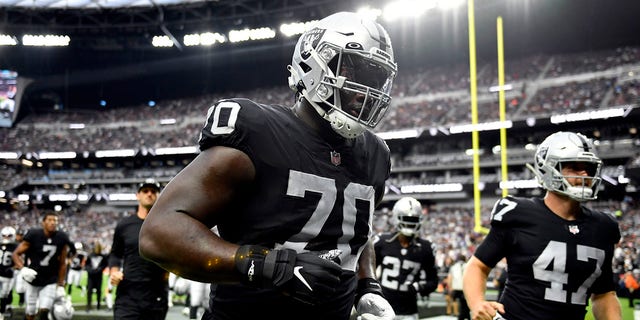 Alex Leatherwood of the Las Vegas Raiders leaves the field after warming up prior to the game against the Baltimore Ravens at Allegiant Stadium in Las Vegas on Sept. 13, 2021.