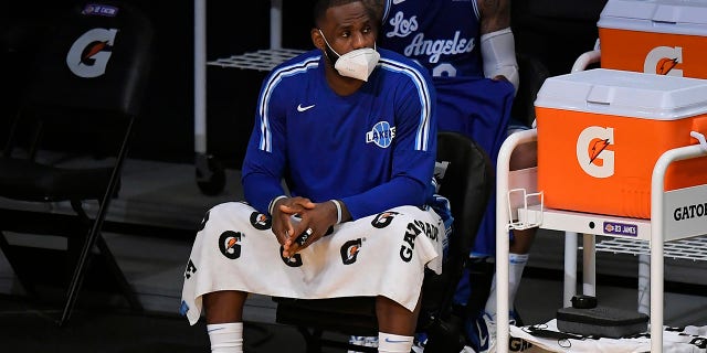 LeBron James of the Los Angeles Lakers wears a face mask on the bench during a game against the Minnesota Timberwolves in Los Angeles on Dec. 27, 2020.