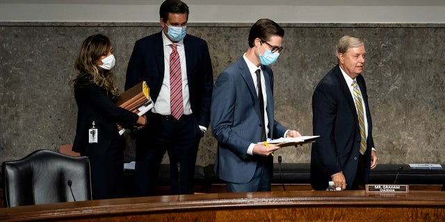 U.S. Senator Lindsey Graham (R-SC) and aides leave at the conclusion of a Senate Judiciary Committee oversight hearing on the Crossfire Hurricane investigation, on Capitol Hill, in Washington, U.S., August 5, 2020. Erin Schaff/Pool via REUTERS