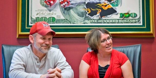 Powerball lottery winners David, left, and Erica Harrig, of Gretna, Neb., speak to the press about their winnings at the law office of their attorney Darren Carlson in Omaha, Neb., on Dec. 13, 2013.