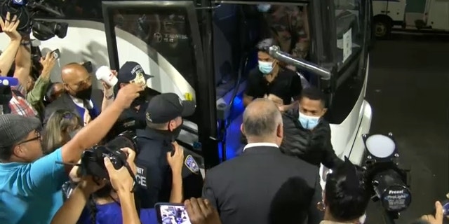 Migrants get off bus Wednesday morning in New York City.