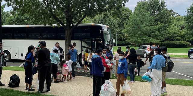 FILE PHOTO: Approximately 30 migrants disembark after arriving on a bus from Texas, at Union Station near the U.S. Capitol in Washington, U.S., July 29, 2022.