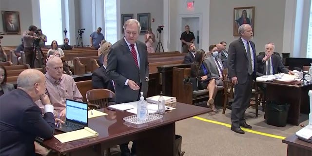 Defense attorney, Dick Harpootlian, center, turns to his client and co-counsel while prosecution addresses the judge.