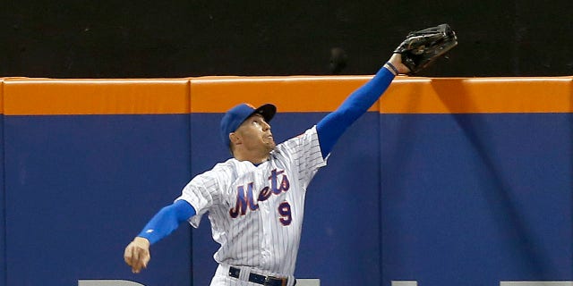 Brandon Nimmo #9 of the New York Mets makes a catch at the wall on a ball off the bat of Justin Turner of the Los Angeles Dodgers in the seventh inning at Citi Field on August 31, 2022 in New York City.