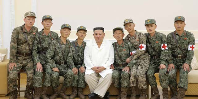 North Korean leader Kim Jung Un poses with military medics during a celebration of their contributions, in Pyongyang, North Korea, on Aug. 18, 2022.