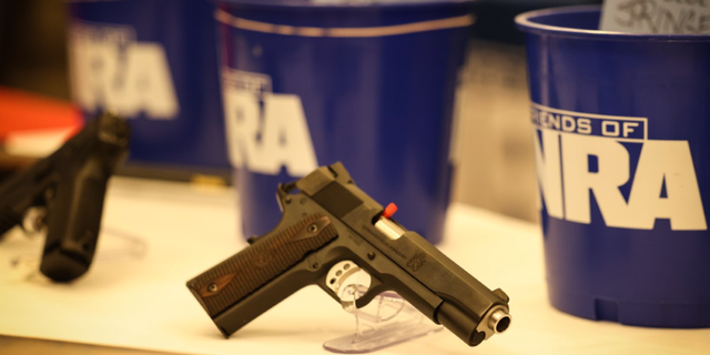 Photo showing firearm sitting on table at NRA affiliated event