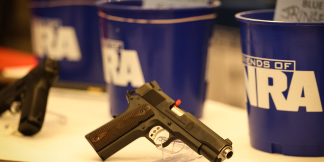 Photo showing firearm sitting on table at NRA affiliated event