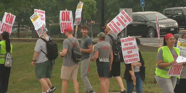 Columbus Education Association teachers picket outside a Columbus city school following the union's rejection of a recent board proposal. 