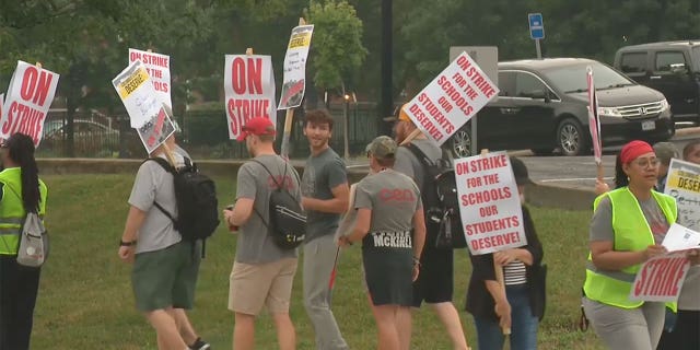 Columbus Education Association teachers picket outside a Columbus city school following the union's rejection of a recent board proposal.