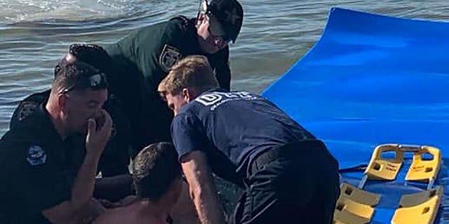 Okaloosa County deputies and Fort Walton police rescued a woman who suffered paralysis to her lower body after jumping from a pontoon boat anchored in shallow water on Sunday.