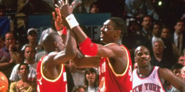 Hakeem Olajuwon, 34, and Vernon Maxwell, 11, of the Houston Rockets won on court during a game against the New York Knicks at Madison Square Garden.  