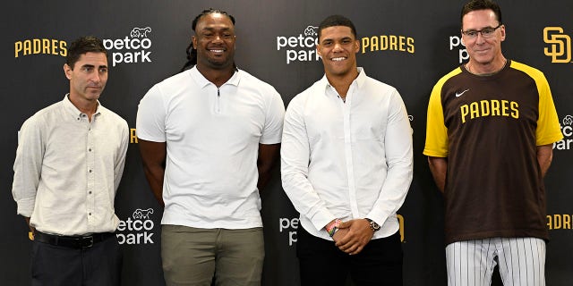 Juan Soto #22 of the San Diego Padres, (2nd R), stands alongside manager Bob Melvin, right, president and general manager A.J. Preller, left, and Josh Bell #19 during a news conference held to introduce them to the team Aug. 3, 2022 at Petco Park in San Diego, California.