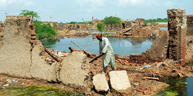 A man searches for recoverable items from his flood-affected home surrounded by water in Jaffarabad, a district of the Pakistani province of Southwest Baluchistan on Sunday, August 28, 2022. Army troops are deployed in the flood-affected area of ​​Pakistan. for urgent relief and relief work as flash floods triggered after heavy monsoon rains across much of the country lashed many districts across all four provinces. 