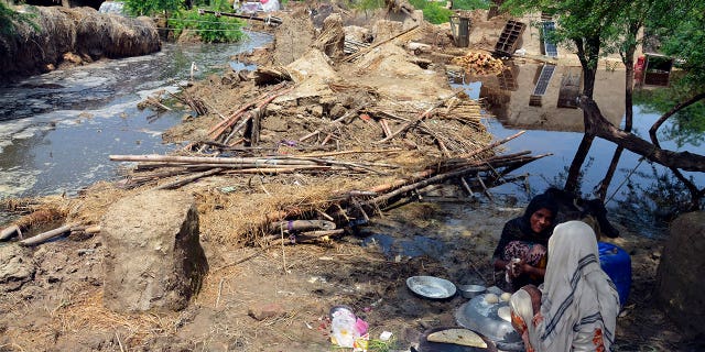 Pakistani women make bread near their flood-damaged homes in the Jafarabad district of Pakistan's southwestern Balochistan province on Sunday, 28 August 2022. Troops are deployed in flood-affected areas of Pakistan for emergency rescue and relief operations as flash floods. Heavy monsoon rains hit most parts of the country, hitting many districts in all four states. 