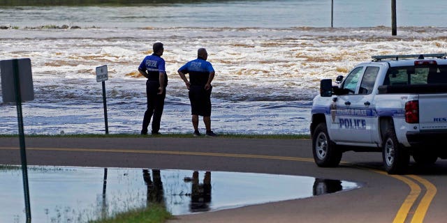 Reservoir police observe the water release from the Ross Barnett Reservoir Spillway onto the Pearl River, Sunday, Aug. 28, 2022, in Rankin County, Miss.