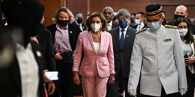 U.S. House Speaker Nancy Pelosi, center, tours the parliament house in Kuala Lumpur, Tuesday, Aug. 2, 2022. Pelosi arrived in Malaysia on Tuesday for the second leg of an Asian tour that has been clouded by an expected stop in Taiwan, which would escalate tensions with Beijing. 