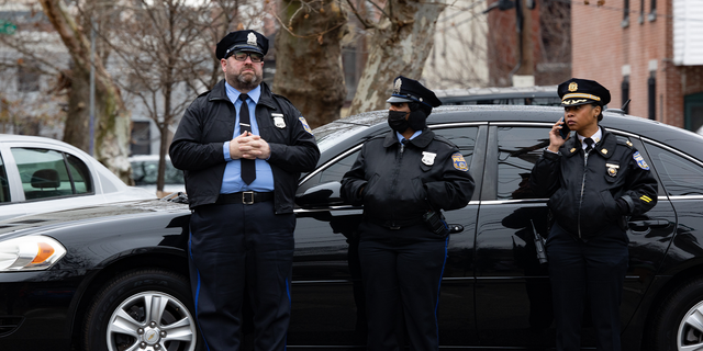 Police and residents are pictured near the scene of the fatal fire in the Fairmount neighborhood on January 5, 2022, in Philadelphia, Pennsylvania.