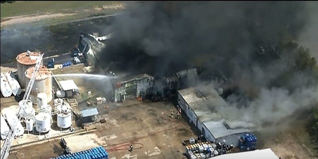Firefighters battle a large blaze on Wednesday at a a chemical packaging plant.