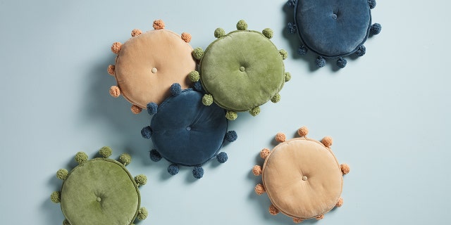 Make a comfy corner in your dorm room with these circular, velvet pillows.
