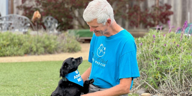 Pompy and his adoptive father John (pictured here) are best friends. Pompy likes to play with his toys and with other dogs.