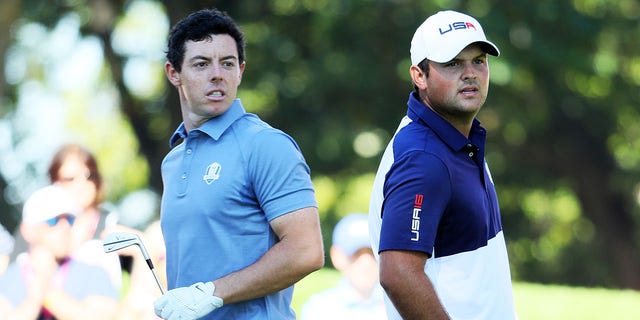 Rory McIlroy of Europe and Patrick Reed of the United States look on from the fourth tee during singles matches of the 2016 Ryder Cup at Hazeltine National Golf Club on Oct. 2, 2016, in Chaska, Minnesota.