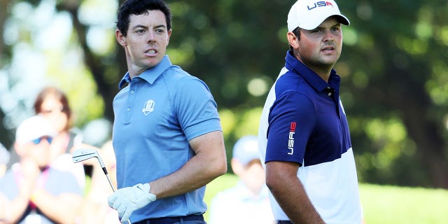 Rory McIlroy of Europe and Patrick Reed of the United States look on from the fourth tee during singles matches of the 2016 Ryder Cup at Hazeltine National Golf Club on Oct. 2, 2016, in Chaska, Minnesota.