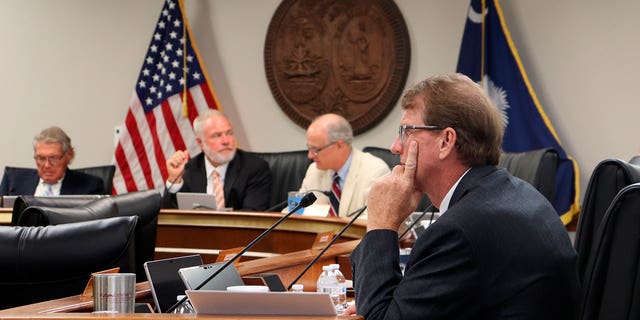 State Sen. Richard Cash, center, a leading supporter of South Carolina's recently implemented Fetal Heartbeat law banning abortion around six weeks, sits during a Senate Medical Affairs Committee meeting, Wednesday, Aug. 17, 2022, in Columbia, S.C. 
