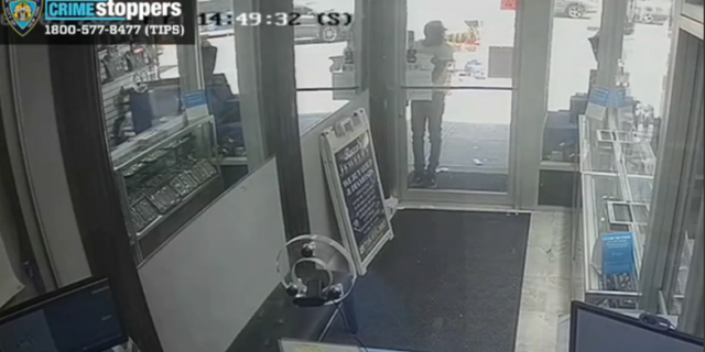 A suspected of Rocco's Jewelry before opening the door for the rest of the thieves.