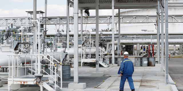 Oil begins flowing from Russian pipelines after Hungary paid travel fees to Ukraine. Pictured: Pipeline worker walks near Druzhba oil pipeline at Mero central oil tank farm, near Nelahozeves, Czech Republic, on Aug. 10, 2022.