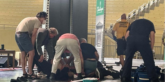 Author Salman Rushdie is tended to after he was attacked during a lecture, Friday, Aug. 12, 2022, at the Chautauqua Institution in Chautauqua, N.Y., about 75 miles (120 km) south of Buffalo. (AP Photo/Joshua Goodman)