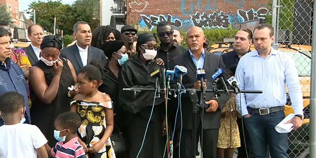 Kutin Gyimah's widow and children gather for a press conference with the New York State Federation of Taxi Drivers.