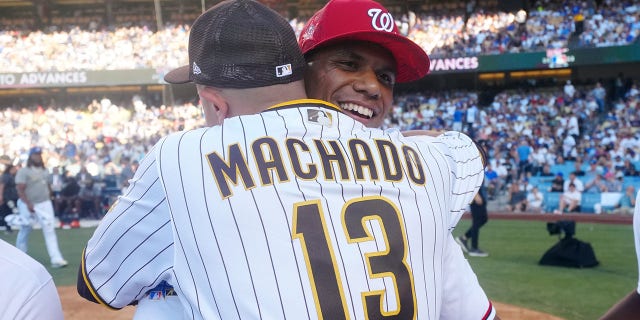 Juan Soto of the Washington Nationals hugs Manny Machado (13) of the San Diego Padres during the T-Mobile Home Run Derby at Dodger Stadium July 18, 2022, in Los Angeles.