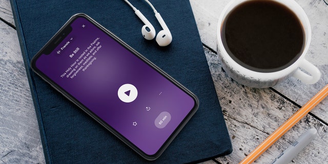 Hallow app on phone and cup of coffee