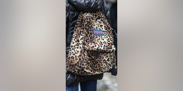 A guest wears a leopard print JanSport backpack bag, outside the Elie Saab show, during Paris Fashion Week Womenswear Fall/Winter 2017/2018, on March 4, 2017, in Paris, France.