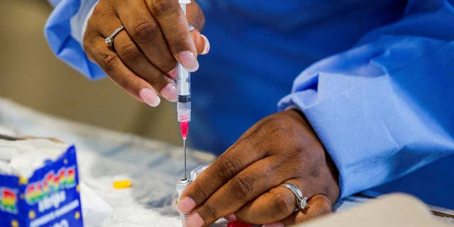 Switzerland plans on acquiring 40,000 doses of the moneybox vaccine. Pictured, monkeypox vaccine doses are loaded into a syringe by a medical worker at Westchester Medical Center in Valhalla, New York, on July 28, 2022.